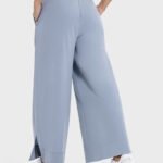 Light blue drape wide-leg pants featuring a side split, shown from the side.