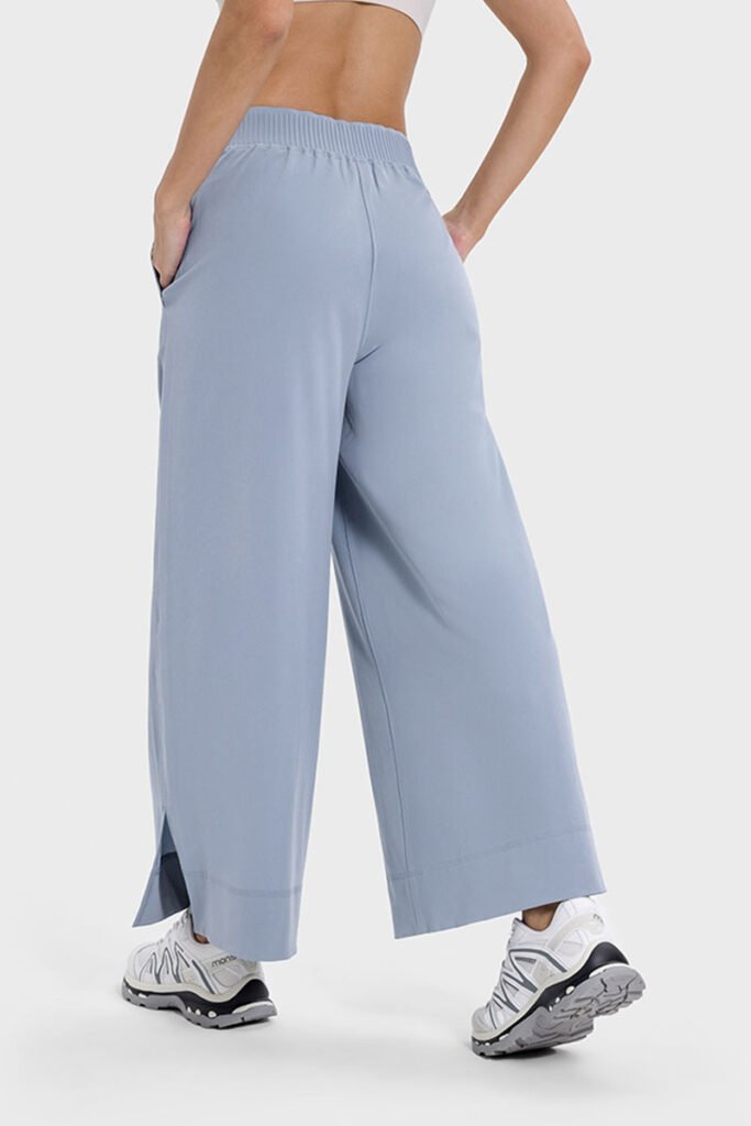 Light blue drape wide-leg pants featuring a side split, shown from the side.