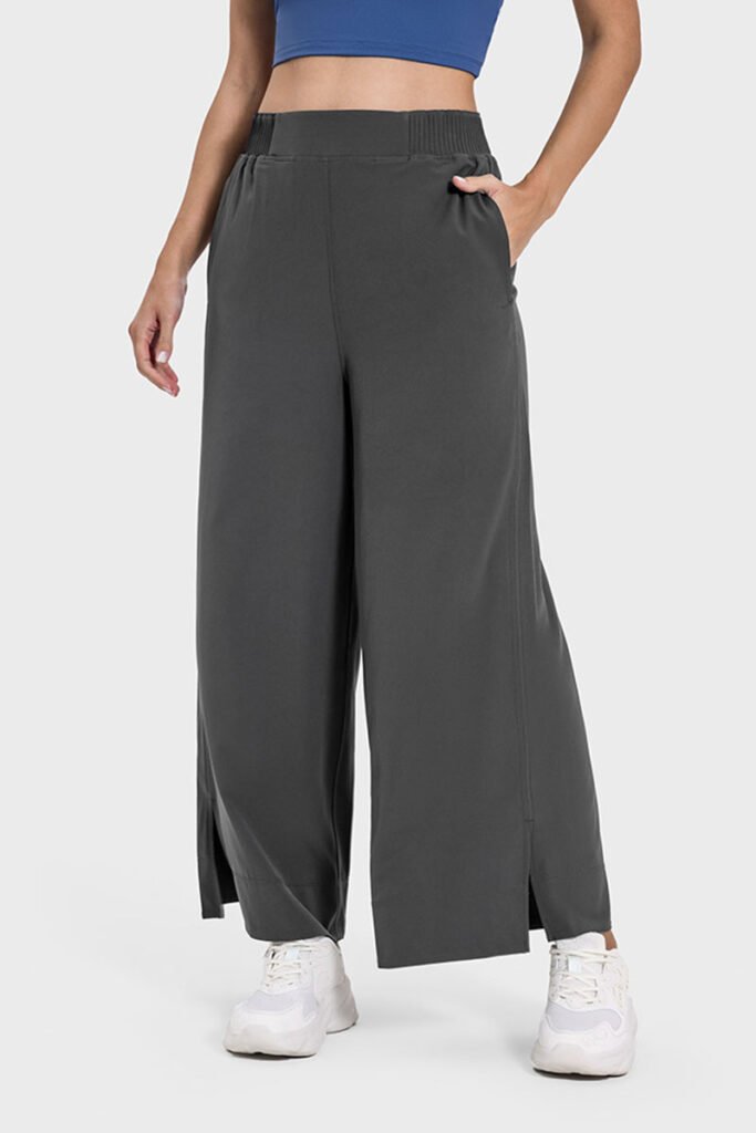 Dark gray drape wide-leg pants with a side split, shown from the side.