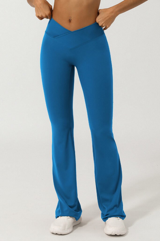 Blue flare yoga pants cross waistband design, ideal for gym and yoga sessions.