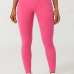 Woman wearing pink high-waisted cross waist leggings